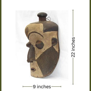 May include: A white ceramic mug with a black handle and the text "But First, Coffee" in a bold, black font. The mug is set against a blurred background, suggesting a cosy setting.