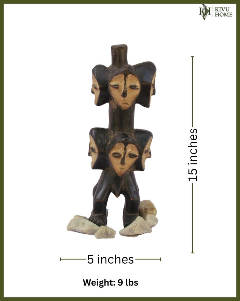 May include: A dark brown wooden sculpture with multiple carved faces. The sculpture is 38 cm tall and 13 cm wide, with a weight of 4.1 kg. The base includes several small, light-coloured stones. The text "KIVU HOME" is in the upper right corner.