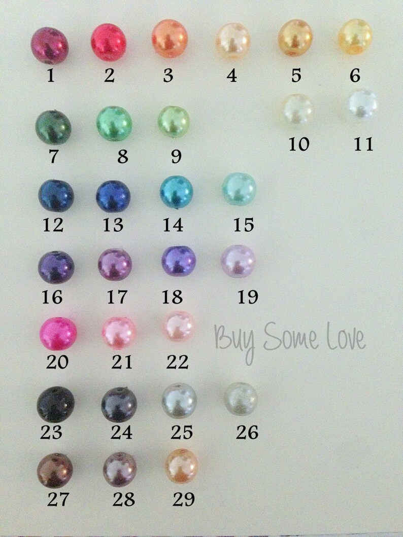 Puede incluir: Un gr&aacute;fico de 29 cuentas de perlas de diferentes colores, numeradas del 1 al 29. El texto "Buy Some Love" est&aacute; impreso debajo de las cuentas.