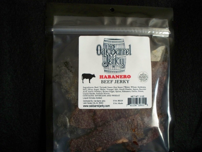 May include: A bag of Oak Barrel Jerky Habanero Beef Jerky. The bag is clear plastic and shows the jerky inside. The label is white with black text and a red barrel logo. The label says "Oak Barrel Jerky" and "Habanero Beef Jerky". The ingredients are listed on the label. The bag is 3 ounces.