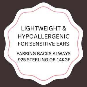 May include: A white star-shaped sticker with pink text that reads "Lightweight & Hypoallergenic for Sensitive Ears Earring Backs Always .925 Sterling or 14KGF"