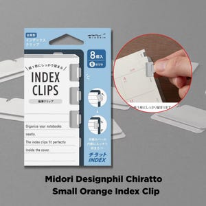 May include: A pack of Midori Designphil Chiratto small orange index clips. The package shows the clips, designed to fit neatly inside a notebook cover. The package contains 8 clips.