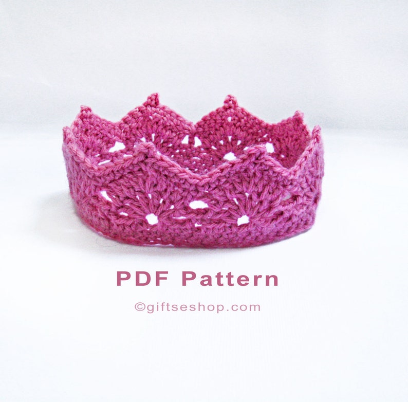 Op de afbeelding: Een roze gehaakte kroon met een kantpatroon. PDF-patroon &copy;giftseshop.com