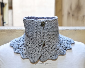 May include: A gray crocheted collar with a scalloped edge and two buttons. The collar is on a white mannequin.