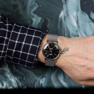 Rare vintage mens watch from the 1970s. A mechanical watch with a unique black dial