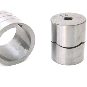 May include: Two metal rings, one with a split design and the other with a smooth surface. The split ring has the number "14" engraved on the side.
