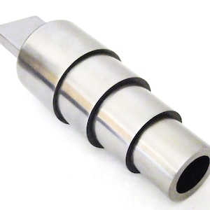 May include: A silver metal tool with a series of concentric rings, designed for expanding or reducing the diameter of a hole.