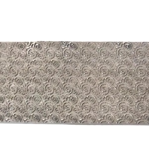 May include: A rectangular, silver-colored metal plate with a repeating, embossed swirl pattern. The plate has a slightly textured surface and is set against a white background. The design is consistent across the entire surface.