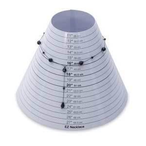 May include: A white cone-shaped tool with black markings and a black beaded necklace wrapped around it. The cone is marked with measurements in inches and centimeters for necklace sizing. The text "EZ Necklace" is printed at the bottom of the cone.