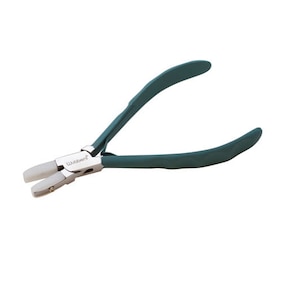 May include: Green handled pliers with white tips and the word "Wubbers" printed on the side.