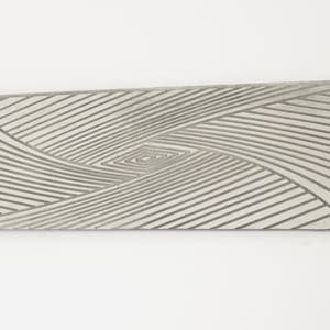 May include: A silver metal rectangular plate with a swirling, geometric pattern etched into the surface.