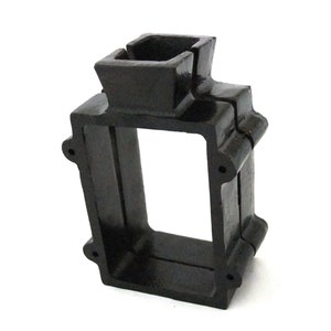 May include: Black cast iron electrical box with a square opening and a rectangular top opening. The box is designed for outdoor use.