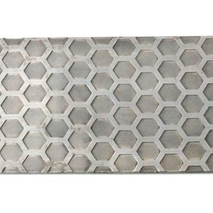 May include: A gray metal honing steel with a hexagonal pattern. The steel is rectangular and has a rough surface.