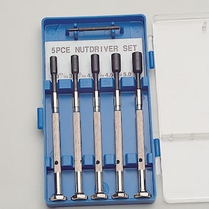 May include: A blue plastic case containing a 5-piece nutdriver set. The set includes nutdrivers in sizes 6mm, 3mm, 4mm, 4.5mm, and 5.0mm. The nutdrivers have silver handles and black tips. The text "5PCE NUTDRIVER SET" is printed on a white label.