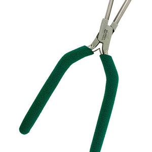 May include: Green handled pliers with a silver metal head. The pliers are labeled "Wubbers Precision Pliers".