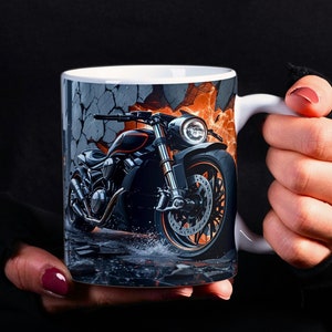 May include: White ceramic mug with a black and orange motorcycle image. The motorcycle is breaking through a cracked wall with orange flames behind it.