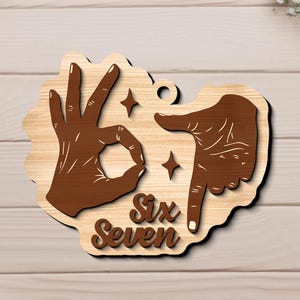 May include: Wooden sign featuring two hands in brown, one forming the 'OK' gesture and the other pointing down. The words 'Six Seven' are in a decorative font. The sign has a light wood grain background and star accents.