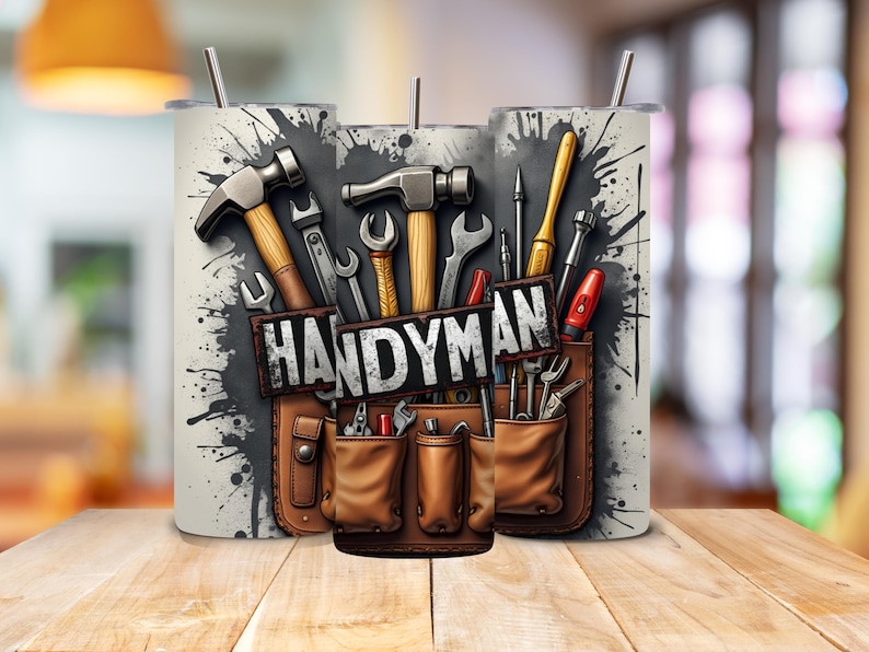 May include: A white tumbler with a graphic of a tool belt with various tools, including hammers, screwdrivers, and wrenches. The text "HANDYMAN" is printed on the tool belt.