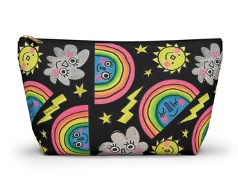May include: Black zippered pouch with a colorful cartoon design. The design features smiling suns, rainbows, clouds, stars, and lightning bolts. The pouch has a gold zipper and the text "Mosha Ink".
