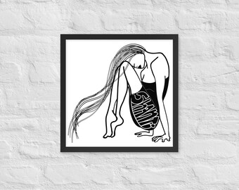 May include: Black and white framed art print. The artwork features a line drawing of a person with long hair, curled up in a seated position. The word "SHAME" is written on the person's leg. The artwork is framed in a black frame.
