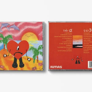 May include: CD case featuring a cartoon heart character on a beach scene with dolphins, palm trees, and a sunset. The back of the case is red with song titles and the Rimas logo.