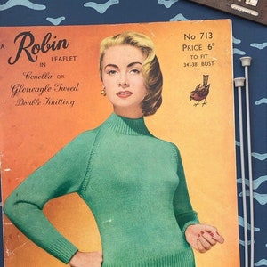 May include: A vintage knitting pattern booklet featuring a woman wearing a green sweater. The cover features the title "A Robin in Leaflet" and the text "Conella OR Gleneagle Tweed Double Knitting". The pattern is number 713 and costs 6 pence. The pattern is for a sweater to fit a bust size of 34-38 inches.