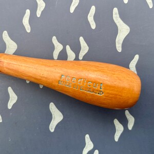 May include: A wood-handled carving tool with a metal ferrule. The handle is light brown with the text "Readicut Made in England" etched in blue. The tool is designed for detailed carving work.