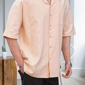 Crafted from high-quality, breathable cotton blend fabric, this stylish shirt offers a soft touch against the skin while ensuring durability. Designed with a relaxed fit, it falls perfectly over the shoulders for that effortlessly chic look. Whether you're lounging at home, running errands, or meeting friends for brunch