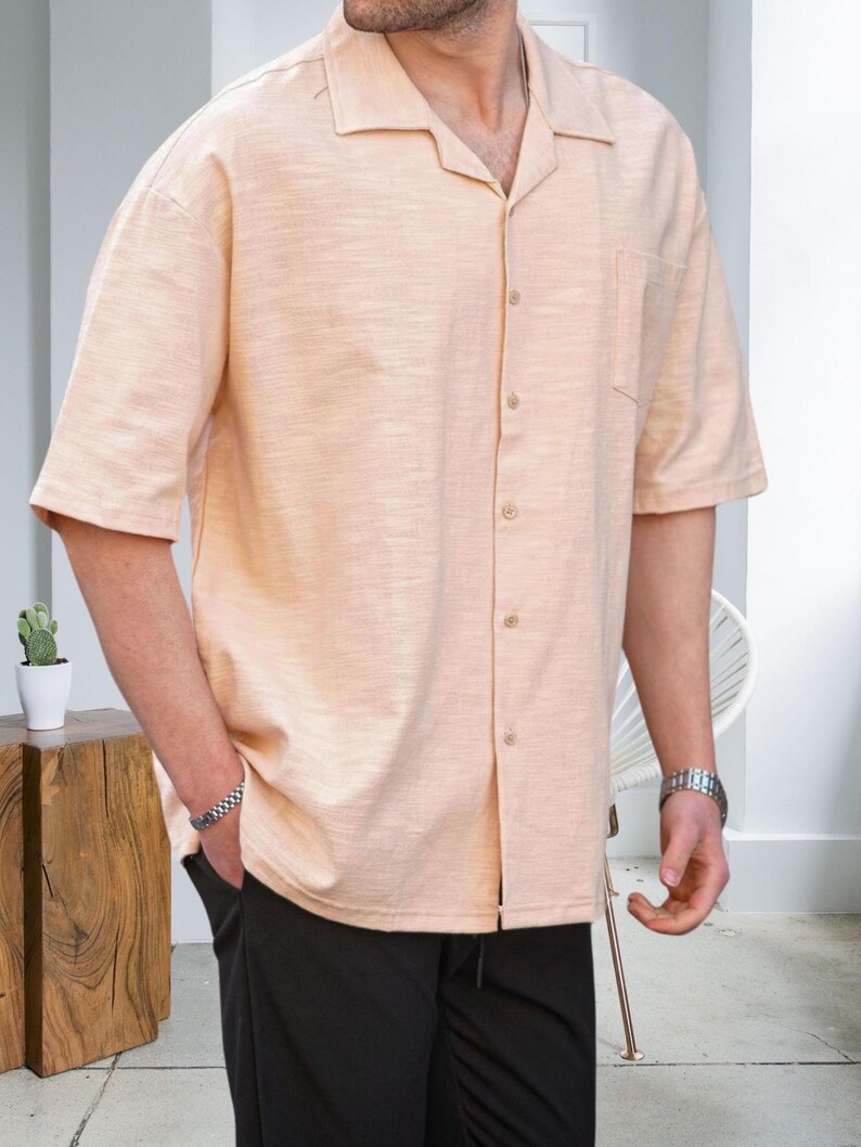 Crafted from high-quality, breathable cotton blend fabric, this stylish shirt offers a soft touch against the skin while ensuring durability. Designed with a relaxed fit, it falls perfectly over the shoulders for that effortlessly chic look. Whether you're lounging at home, running errands, or meeting friends for brunch