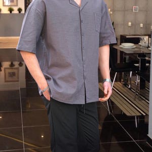 Crafted from high-quality, breathable cotton blend fabric, this stylish shirt offers a soft touch against the skin while ensuring durability. Designed with a relaxed fit, it falls perfectly over the shoulders for that effortlessly chic look. Whether you're lounging at home, running errands, or meeting friends for brunch