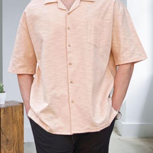 Crafted from high-quality, breathable cotton blend fabric, this stylish shirt offers a soft touch against the skin while ensuring durability. Designed with a relaxed fit, it falls perfectly over the shoulders for that effortlessly chic look. Whether you're lounging at home, running errands, or meeting friends for brunch