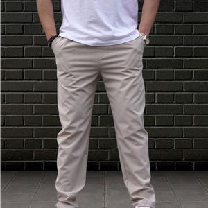 Crafted from a premium blend of soft cotton and a hint of stretch, these lounge trousers ensure a relaxed fit that moves with you. Perfectly suited for lounging at home or stepping out with friends, these classic pants redefine casual wear, making them a versatile addition to any man's closet.