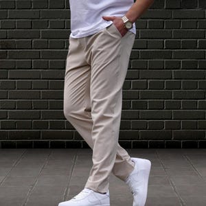 Crafted from a premium blend of soft cotton and a hint of stretch, these lounge trousers ensure a relaxed fit that moves with you. Perfectly suited for lounging at home or stepping out with friends, these classic pants redefine casual wear, making them a versatile addition to any man's closet.
