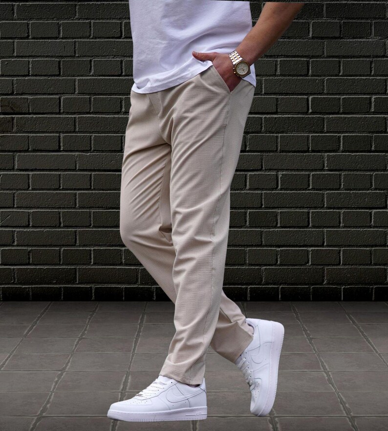 Crafted from a premium blend of soft cotton and a hint of stretch, these lounge trousers ensure a relaxed fit that moves with you. Perfectly suited for lounging at home or stepping out with friends, these classic pants redefine casual wear, making them a versatile addition to any man's closet.