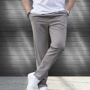 Crafted from a premium blend of soft cotton and a hint of stretch, these lounge trousers ensure a relaxed fit that moves with you. Perfectly suited for lounging at home or stepping out with friends, these classic pants redefine casual wear, making them a versatile addition to any man's closet.