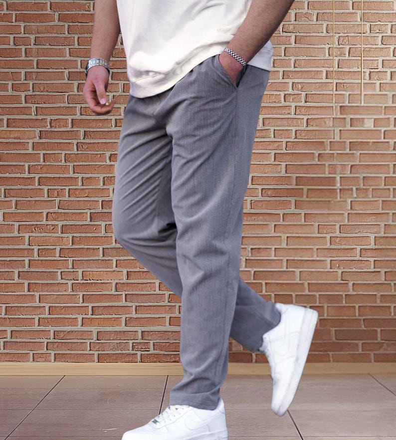 Crafted from a premium blend of soft cotton and a hint of stretch, these lounge trousers ensure a relaxed fit that moves with you. Perfectly suited for lounging at home or stepping out with friends, these classic pants redefine casual wear, making them a versatile addition to any man's closet.