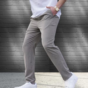 Crafted from a premium blend of soft cotton and a hint of stretch, these lounge trousers ensure a relaxed fit that moves with you. Perfectly suited for lounging at home or stepping out with friends, these classic pants redefine casual wear, making them a versatile addition to any man's closet.