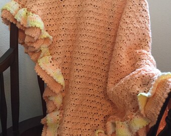 Hand Crocheted Baby Blanket with a Peach, Soft Baby Yarn and Trimmed with a Peach/white Ruffle and a peach colored Ribbon tied in a bow