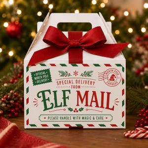 May include: A white gable box with a red ribbon bow on top. The box features green and red text reading "SPECIAL DELIVERY FROM ELF MAIL" and "PLEASE HANDLE WITH MAGIC & CARE," along with "OFFICIAL NORTH POLE DELIVERY" and "NORTH POLE EXPRESS" stamps.