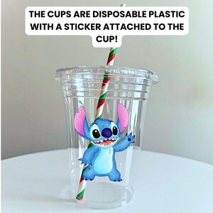 May include: A clear plastic cup with a red and green striped straw. A blue cartoon character with large ears is on the cup. The text "THE CUPS ARE DISPOSABLE PLASTIC WITH A STICKER ATTACHED TO THE CUP!" is above the cup.