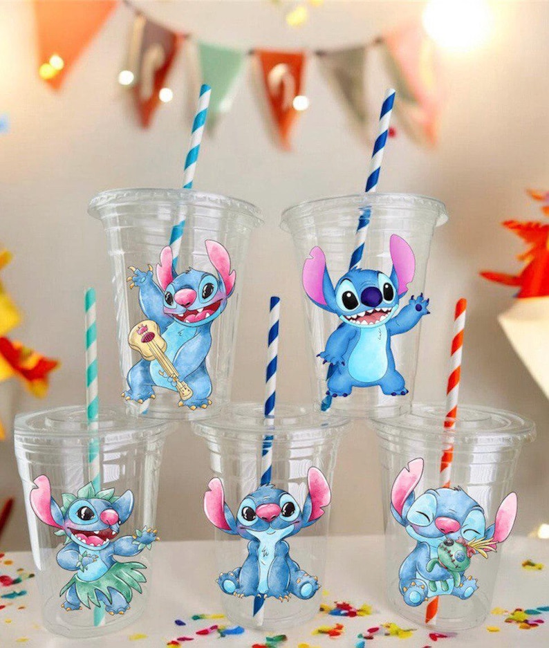May include: Five clear plastic cups with blue and white striped straws. Each cup has a different cartoon image of Stitch from Lilo & Stitch. The images include Stitch playing a ukulele, Stitch waving, Stitch wearing a grass skirt, Stitch sitting, and Stitch holding a flower.