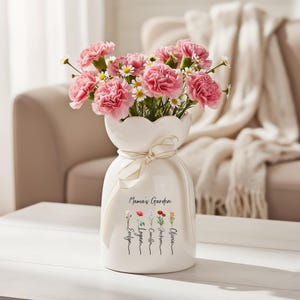 May include: A set of three ceramic mugs with a speckled, matte finish. The mugs are in shades of cream, light gray, and dark gray. Each mug has a simple, minimalist design and a rounded handle.