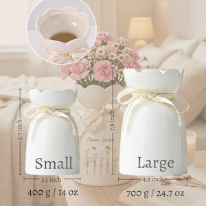 May include: A set of three ceramic mugs with a speckled, matte finish. Each mug features a different color: light blue, cream, and gray. The mugs have a simple, modern design with a rounded shape and a comfortable handle.