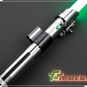 May include: A silver and black lightsaber with a bright green blade. The hilt features a ribbed design and several buttons and switches. The text "TSABERS" is displayed in neon green and red.