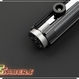 May include: A black and silver lightsaber with a ribbed handle and a circular emitter. The lightsaber has a glossy finish and a black accent piece near the top. The logo "TSABERS" is displayed in neon colors.