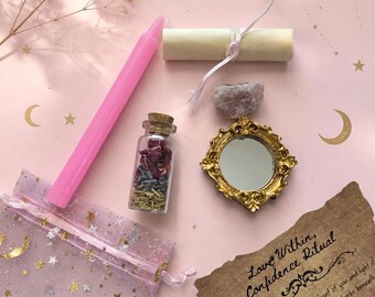 May include: A ritual kit containing a pink taper candle, a small glass bottle filled with dried herbs and flower petals, a miniature gold-toned ornate mirror topped with a raw rose quartz crystal, a rolled parchment scroll, and a sheer organza bag.