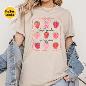 First Grade Teacher Shirt: Strawberry Coquette Back To School Cotton Tee
