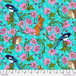 May include: A whimsical fabric design featuring a teal background with a repeating pattern of pink flowers, green vines, magpies, hedgehogs, and a rabbit knitting with blue yarn. The design includes the text "Free Spirit Fabrics".