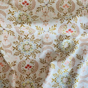 May include: White fabric with a repeating pattern of brown, orange, and blue floral designs. The pattern features stylized leaves, flowers, and circles.