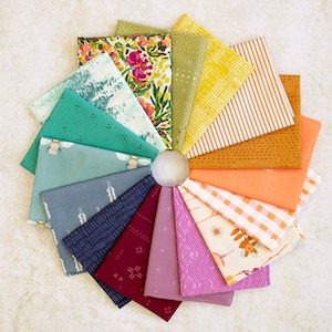 May include: A collection of 15 fabric squares in various patterns and colors, including floral, geometric, and striped designs. The fabric squares are arranged in a circle, with the edges of each square overlapping.